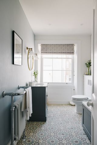 white bathroom with encaustic tile flooring