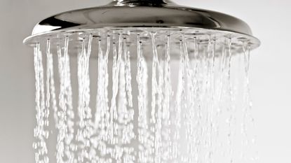 Water droplets falling from a metal shower head