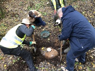 Volunteers excavate part of the exploded V1 "flying bomb" that crashed in a forest in southeast England in 1944.