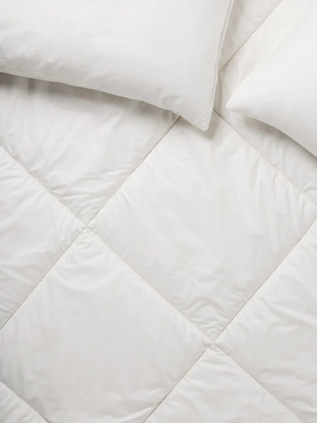 A white merino wool mattress topper from Piglet in Bed