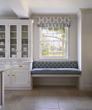 White kitchen with blue and white striped window seat