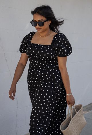 a photo of a woman wearing a print dress with polka dots
