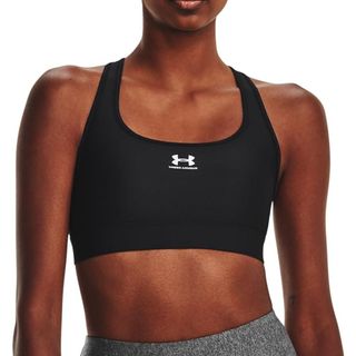 A woman in a sports bra for an EMOM workout