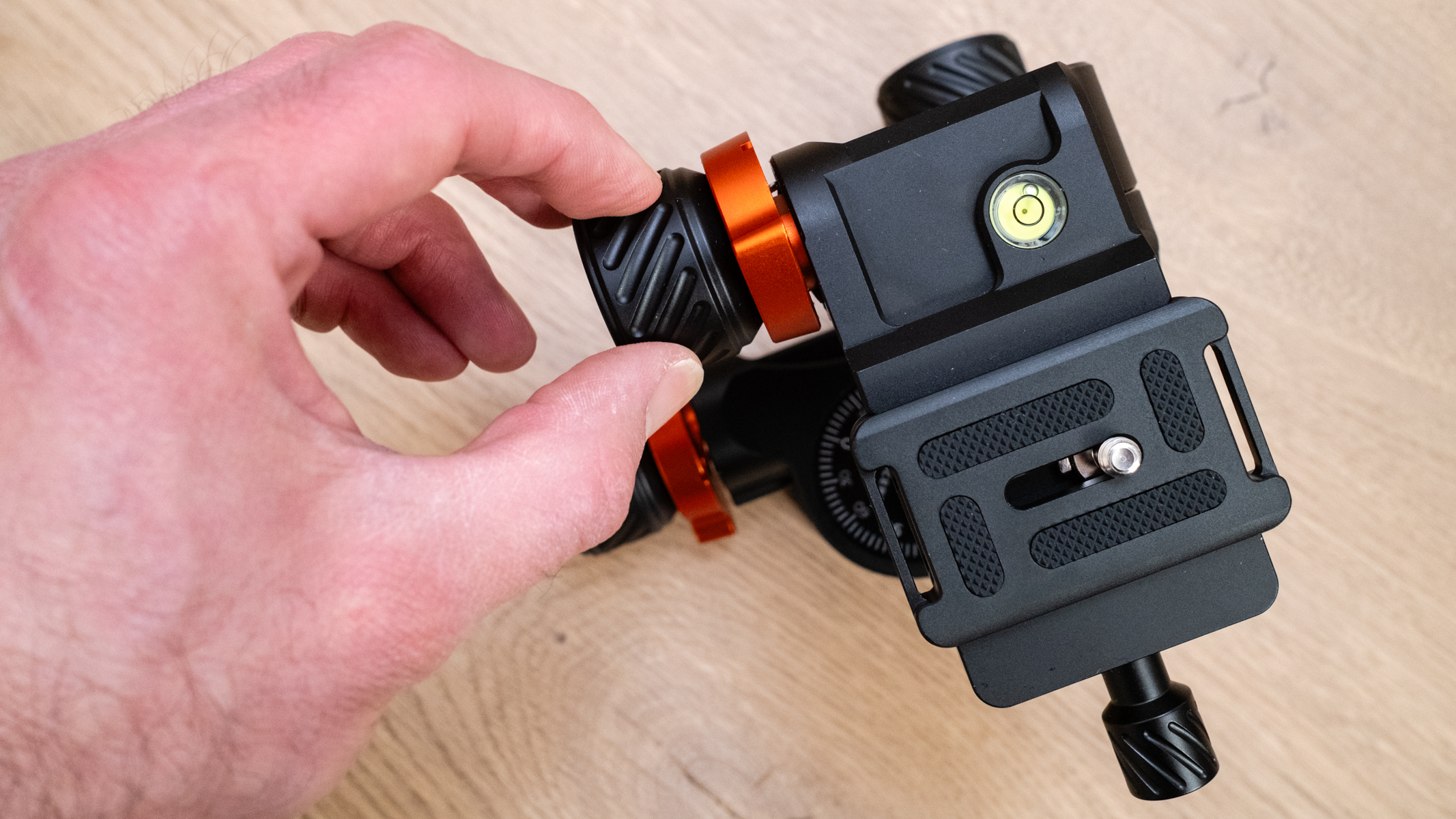 K&F Concept 3-Way Geared Tripod Head with a hand turning a geared knob