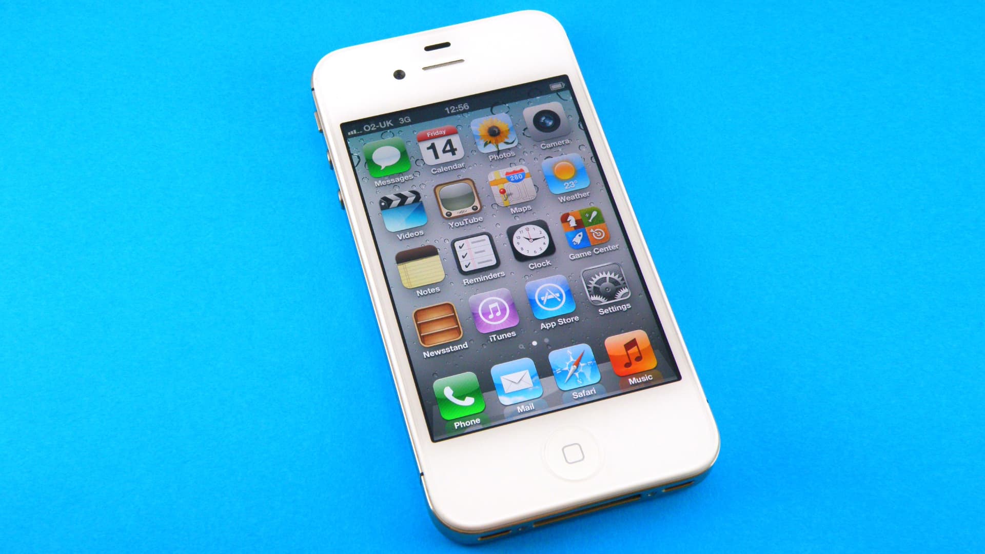 An Apple iPhone 4s against a blue background.