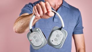 The Nothing Headphone (1) held in a man's hand