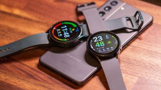 Samsung Galaxy Watch 5 vs Galaxy Watch 4 overlapping and sitting on top of Galaxy S21 FE