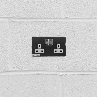 White wall with chrome double plug socket