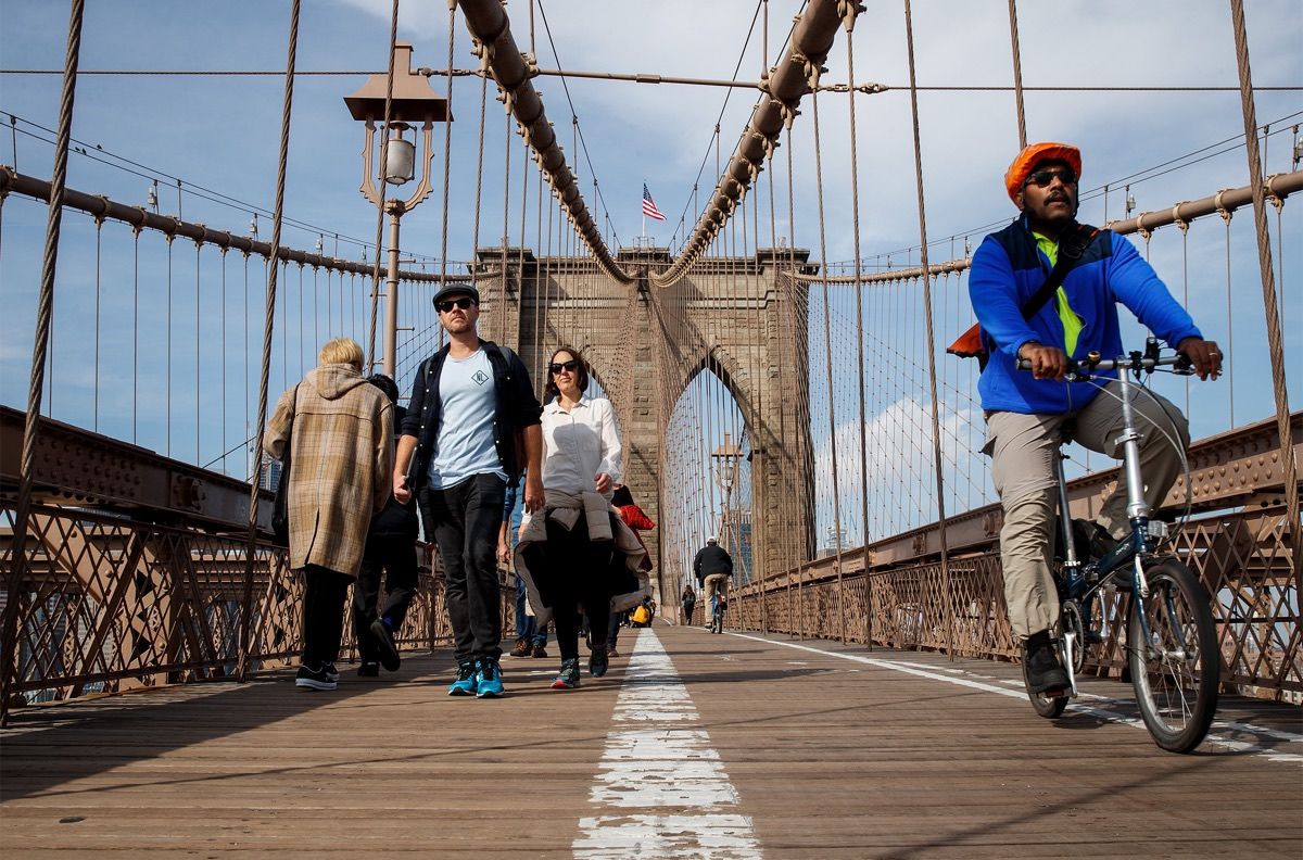 Pedestrians and cyclists cross the Brooklyn Bridge, Feb. 8, 2017, in New York City, where temperatures reached 60 degrees Fahrenheit (16 degrees Celsius).