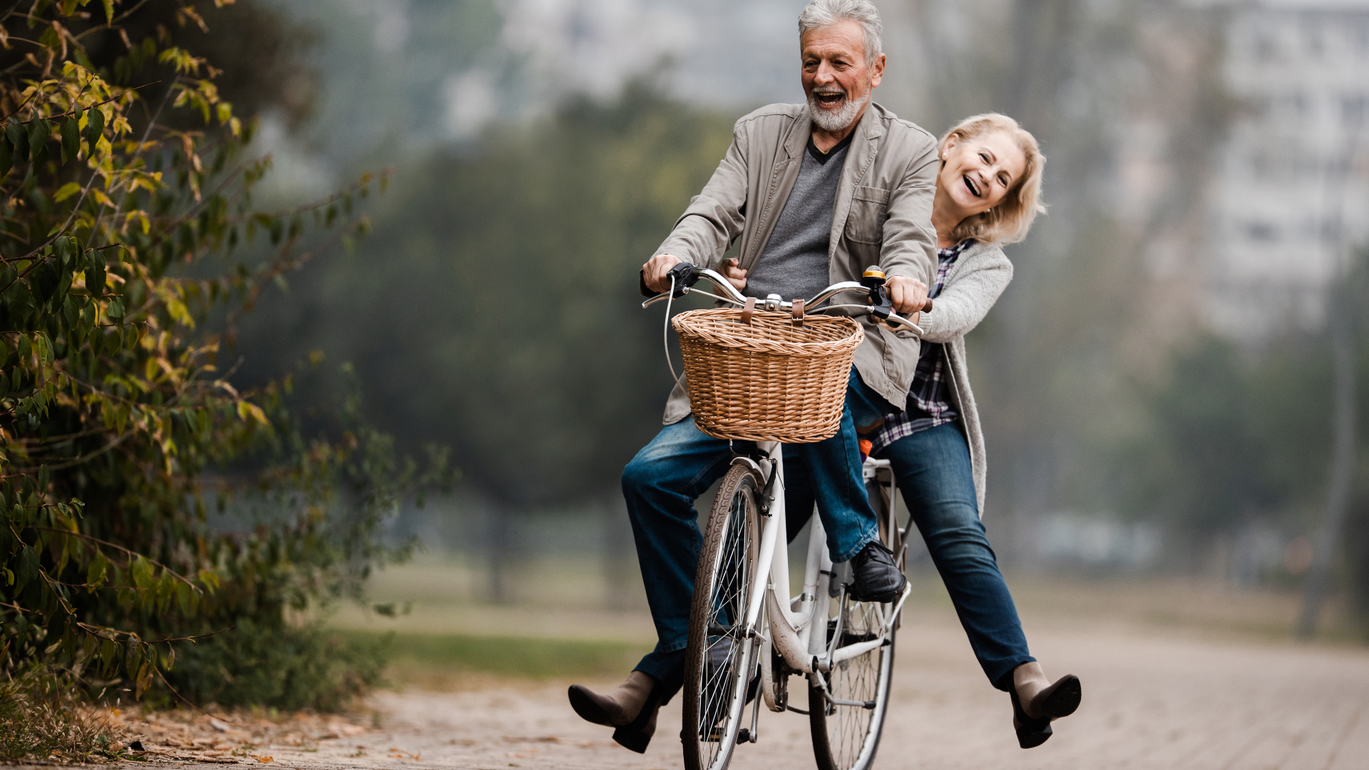 A senior couple ride a bike together