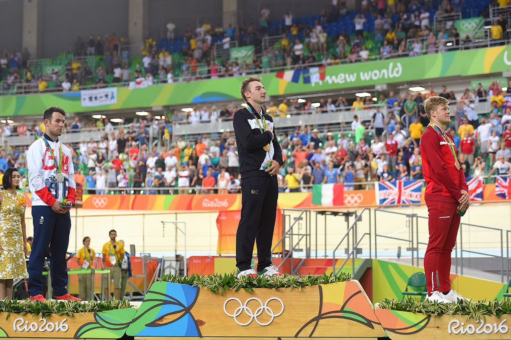 Elia Viviani (Italy) listens as the Italian national anthem plays