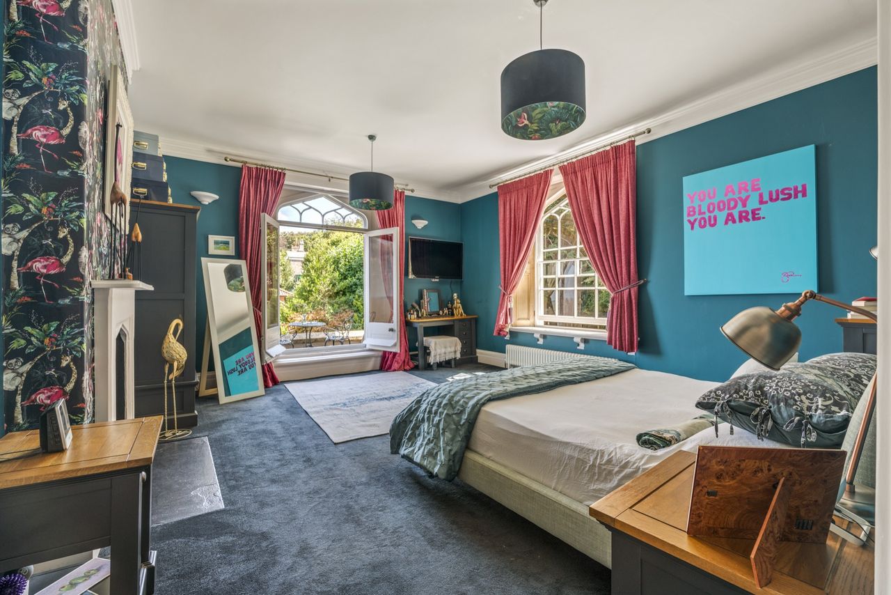 Detail of the interiors of Woodside, featuring lots of soft blues, funky artwork, wooden floors, and natural light
