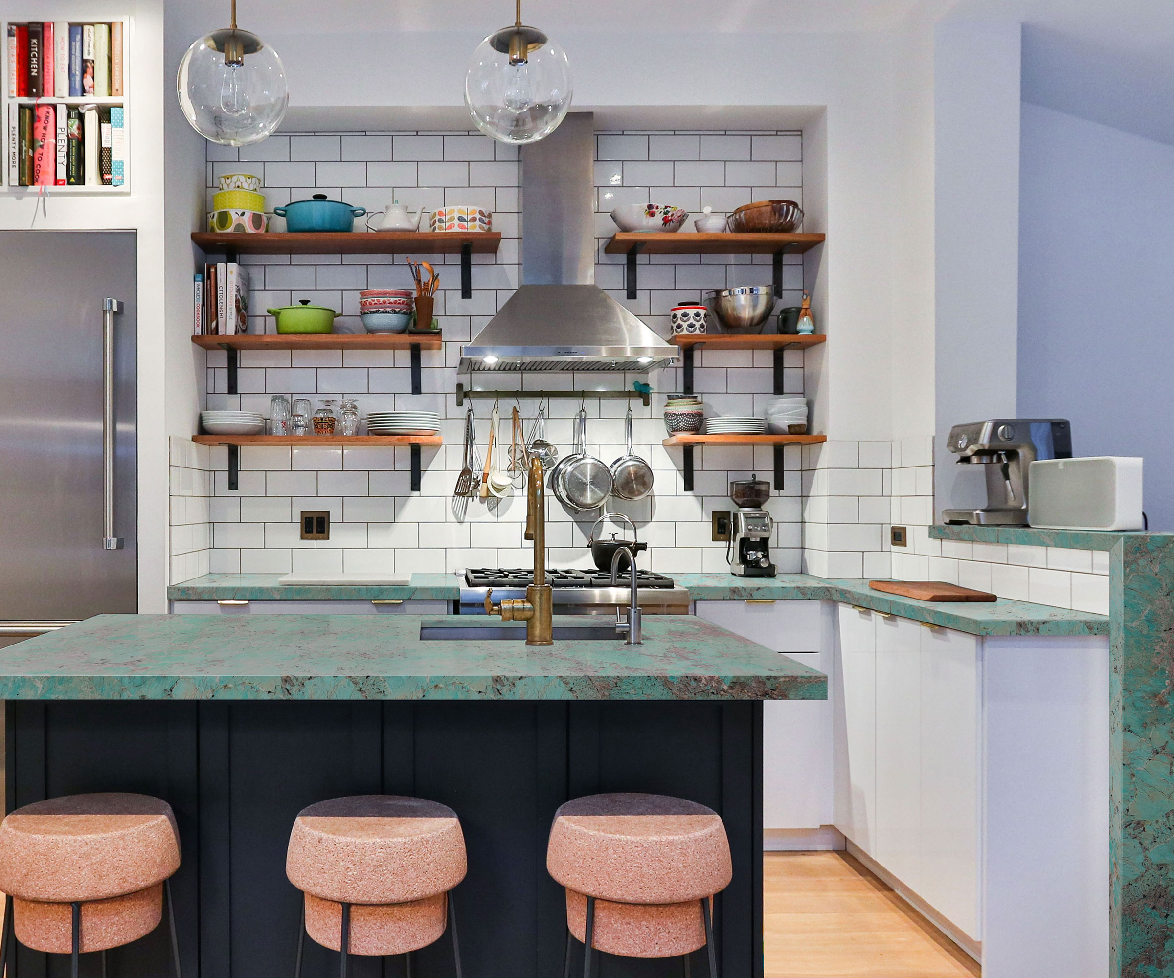 white kitchen with black kitchen island with green composite stone worktops