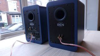 Kanto Ren speakers in blue, within a hi-fi listening room