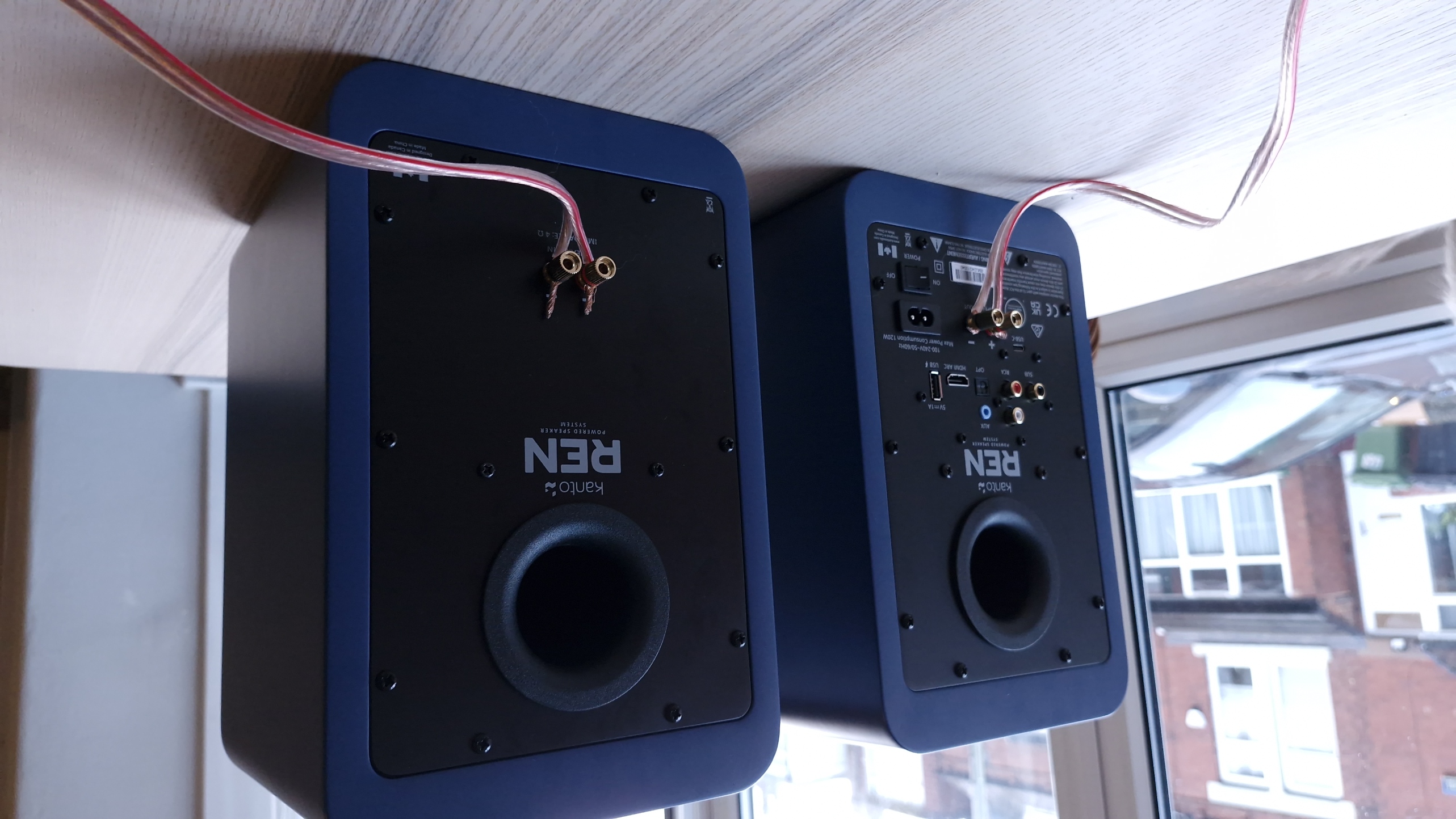 Kanto Ren speakers in blue, within a hi-fi listening room