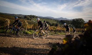 A group of riders on the Scott Solace Gravel eRide 10 bikes on a gravel path with green hills in the distance