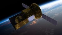 a gold-foiled satellite floats in space above Earth, with two, three-panel solar arrays on either side.