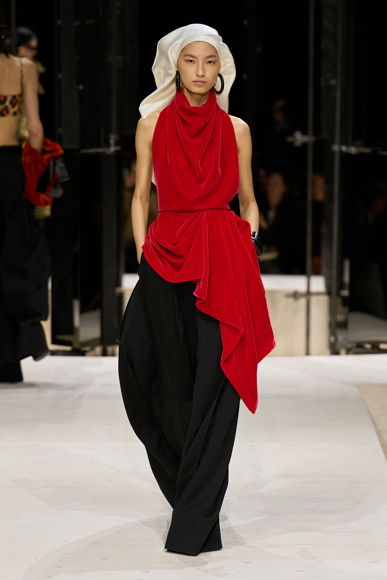 a model wears a headcovering on the givenchy f/w 26 runway.