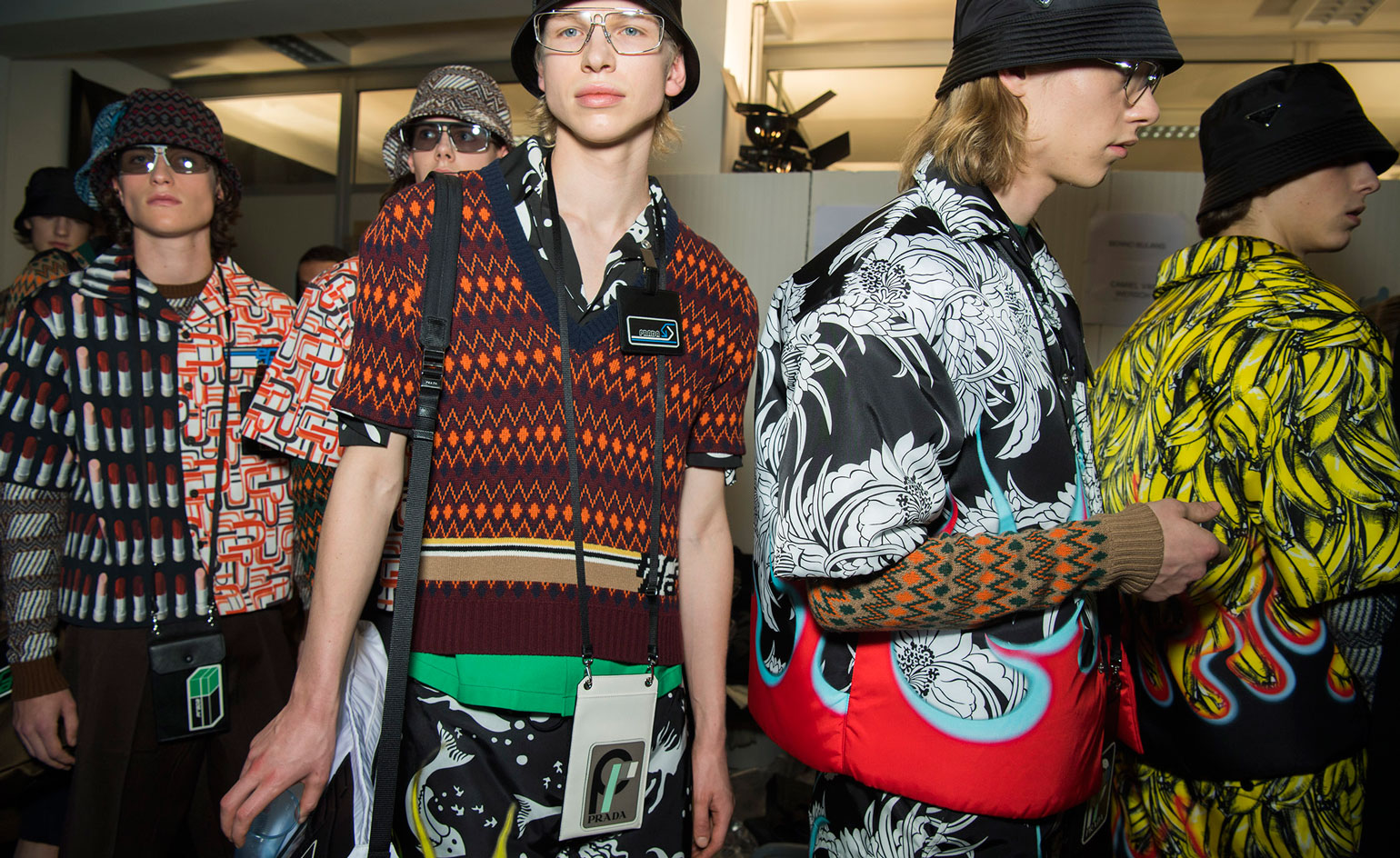 A group of young men wearing colourful patterned shirts.