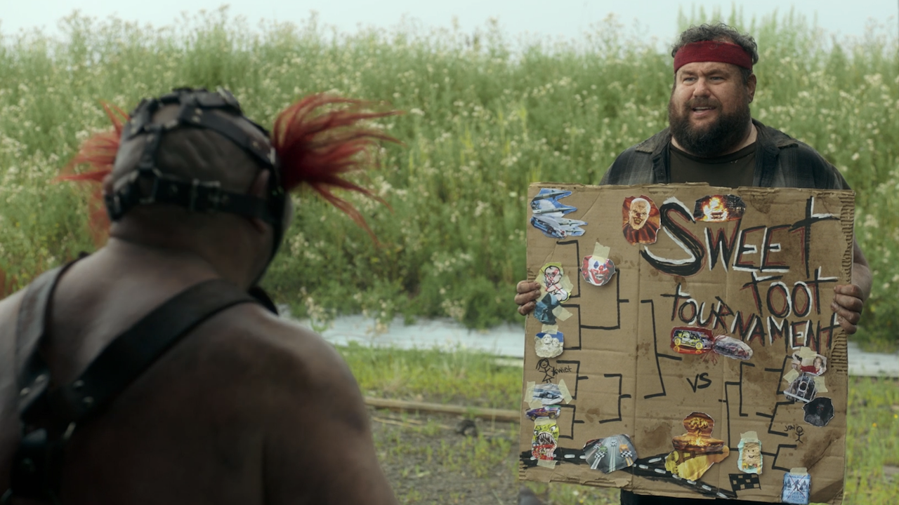 Stu showing Sweet Tooth his handmade Sweet Toot Tournament bracket in Twisted Metal Season 2
