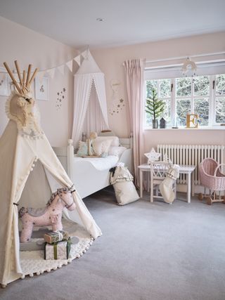 girls pink bedroom with teepee and rocking horse