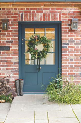 oak frame house exterior front door with christmas wreath
