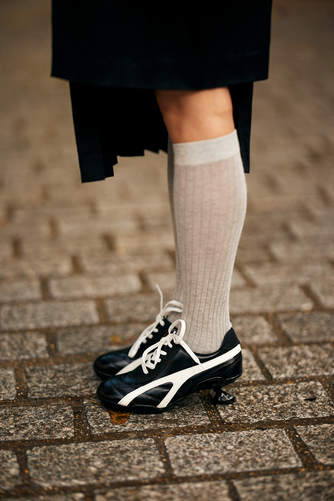 woman wearing black sneakers and white socks