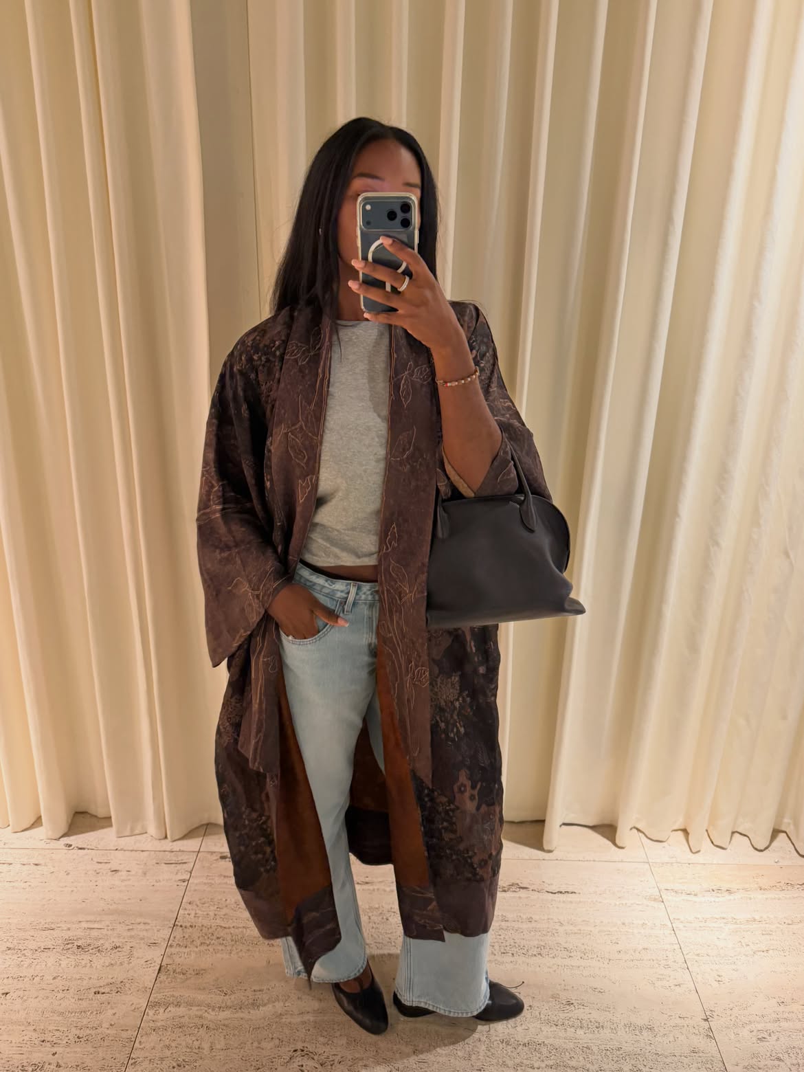 fashion influencer @Nlmarilyn wearing an embroidered silk duster coat with jeans
