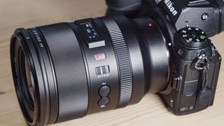 Viltrox AF 35mm F1.2 LAB Z lens for Nikon, attached to a Nikon Z6 II, on a wooden table, close. up of the controls