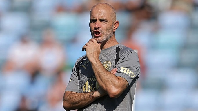Enzo Maresca scratches his chin during a Manchester City training session.