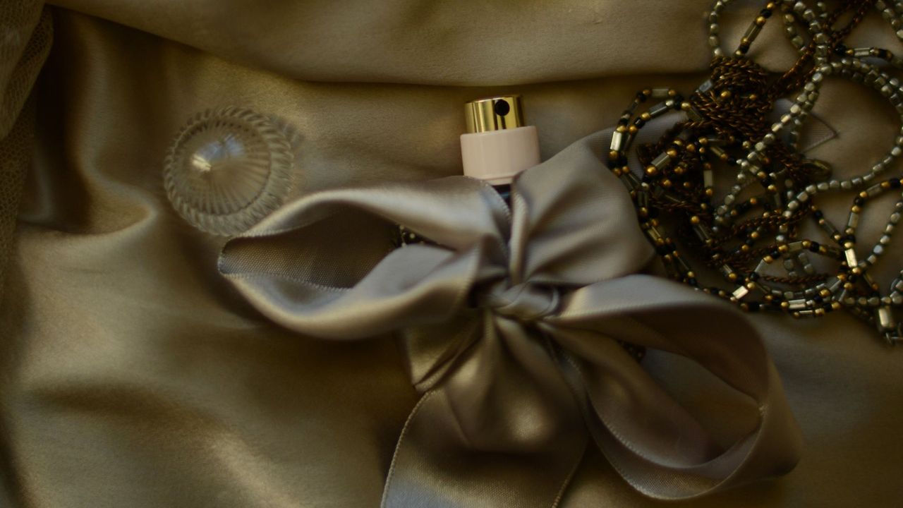 A festive perfume wrapped in a gold bow