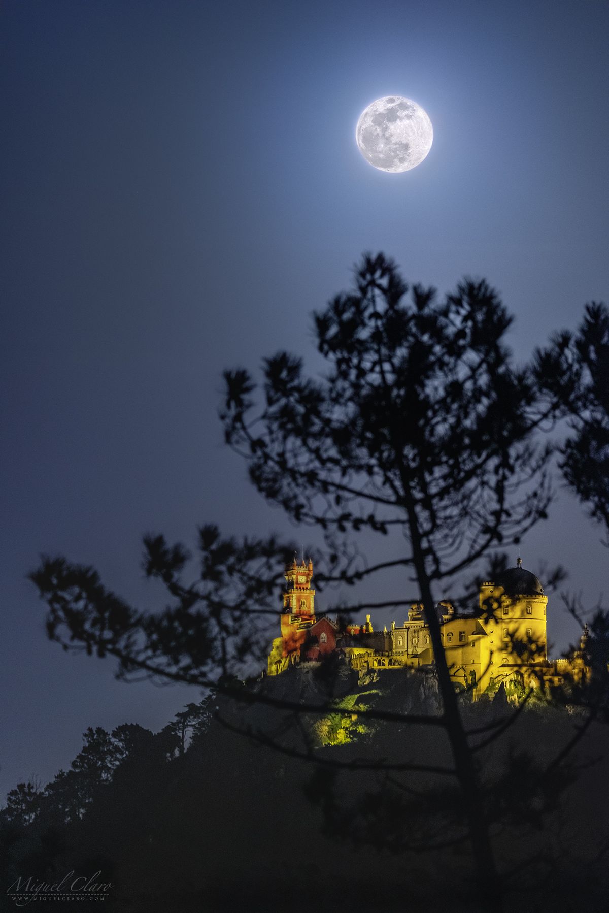 A &quot;Super Snow Moon&quot; shines above the Pena Palace (Palácio da Pena), a Romanticist hilltop castle overlooking the town of Sintra, Portugal.