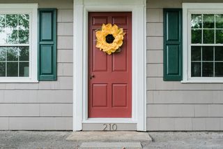 Sunflower wreath decorating the entrance door of a residential home