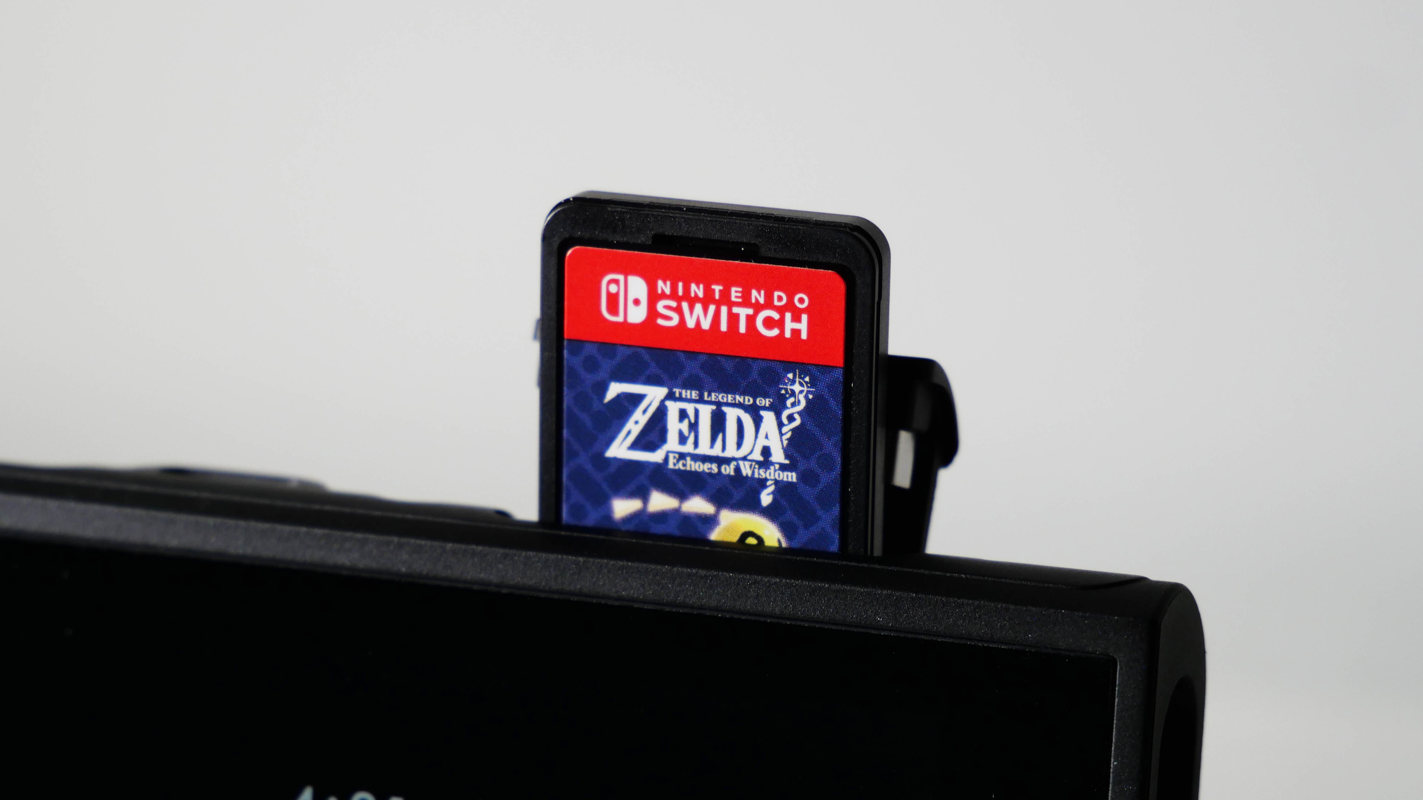Nintendo Switch 2 against a white background, highlighting the Echoes of Wisdom cartridge popping out of the game cartridge slot.