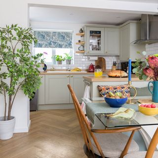 kitchen diner with glass dining table and wooden chairs