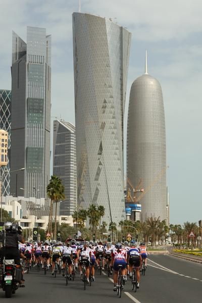 The bunch heads towards the Doha skyline during the neutralised section