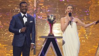 Alfonso and Julianne stand next to the Len Goodman Mirrorball trophy