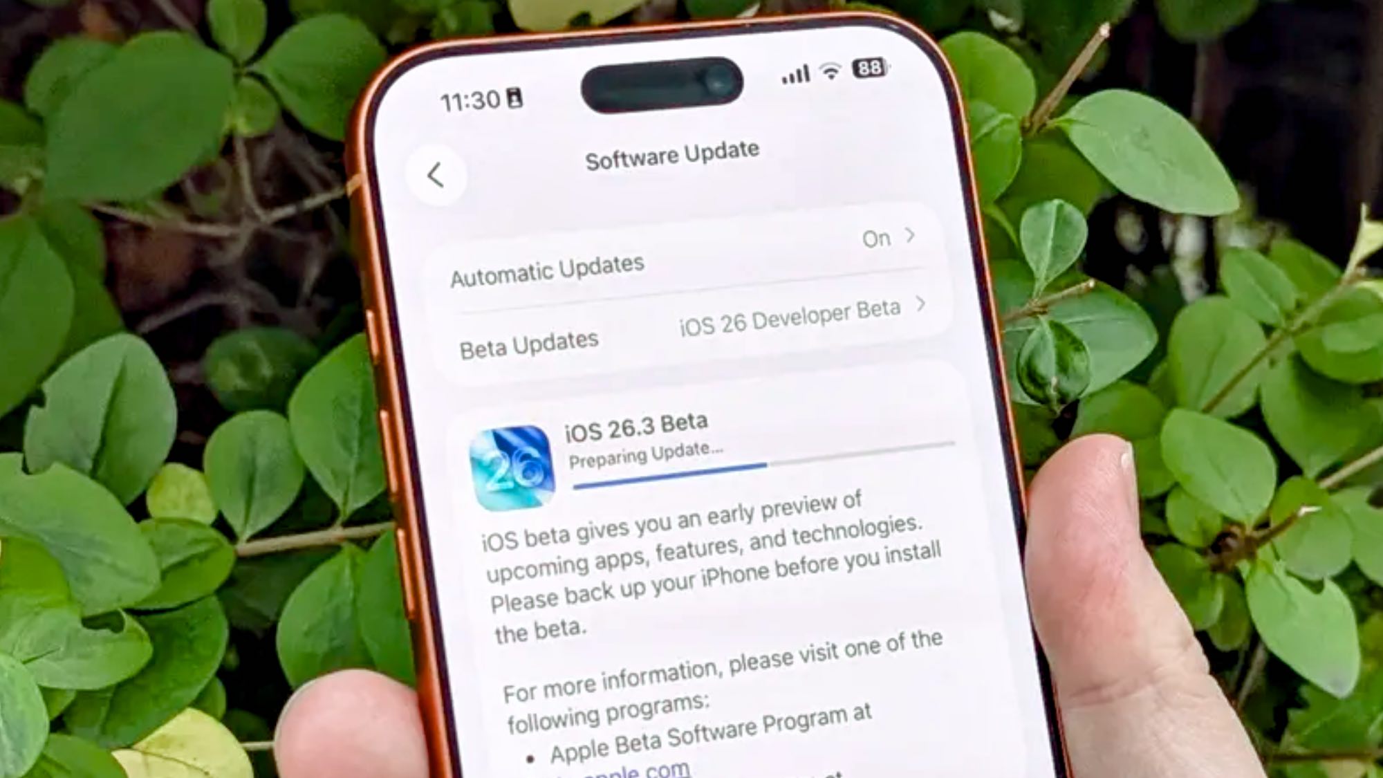 iOS 26.3 running on iPhone in hand 