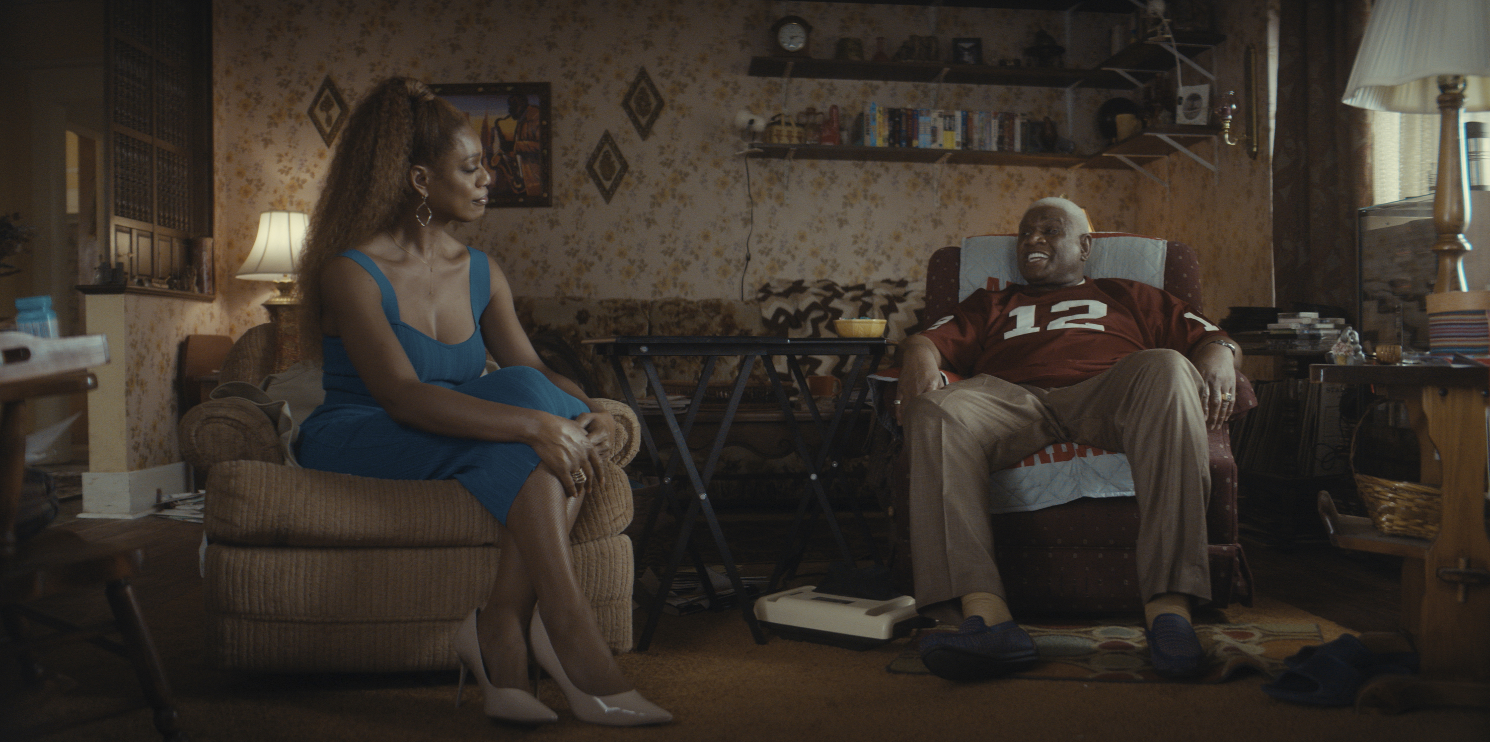 Two people (Laverne Cox as Desiree, George Wallace as Harry) sit in a cluttered living room, in 'Clean Slate.'