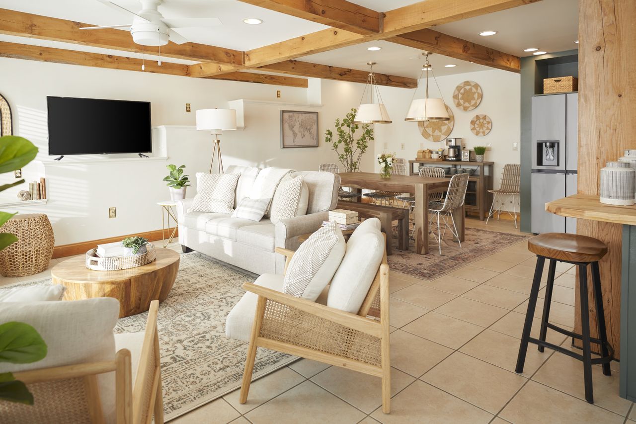 A living area with white sofas and wooden furnsishings