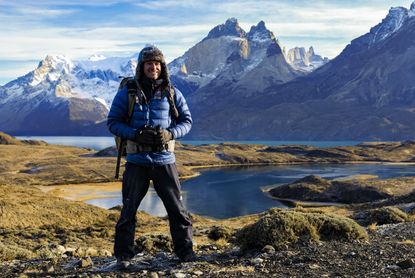 Bertie Gregory in front of a lake and mountain in Patagonia