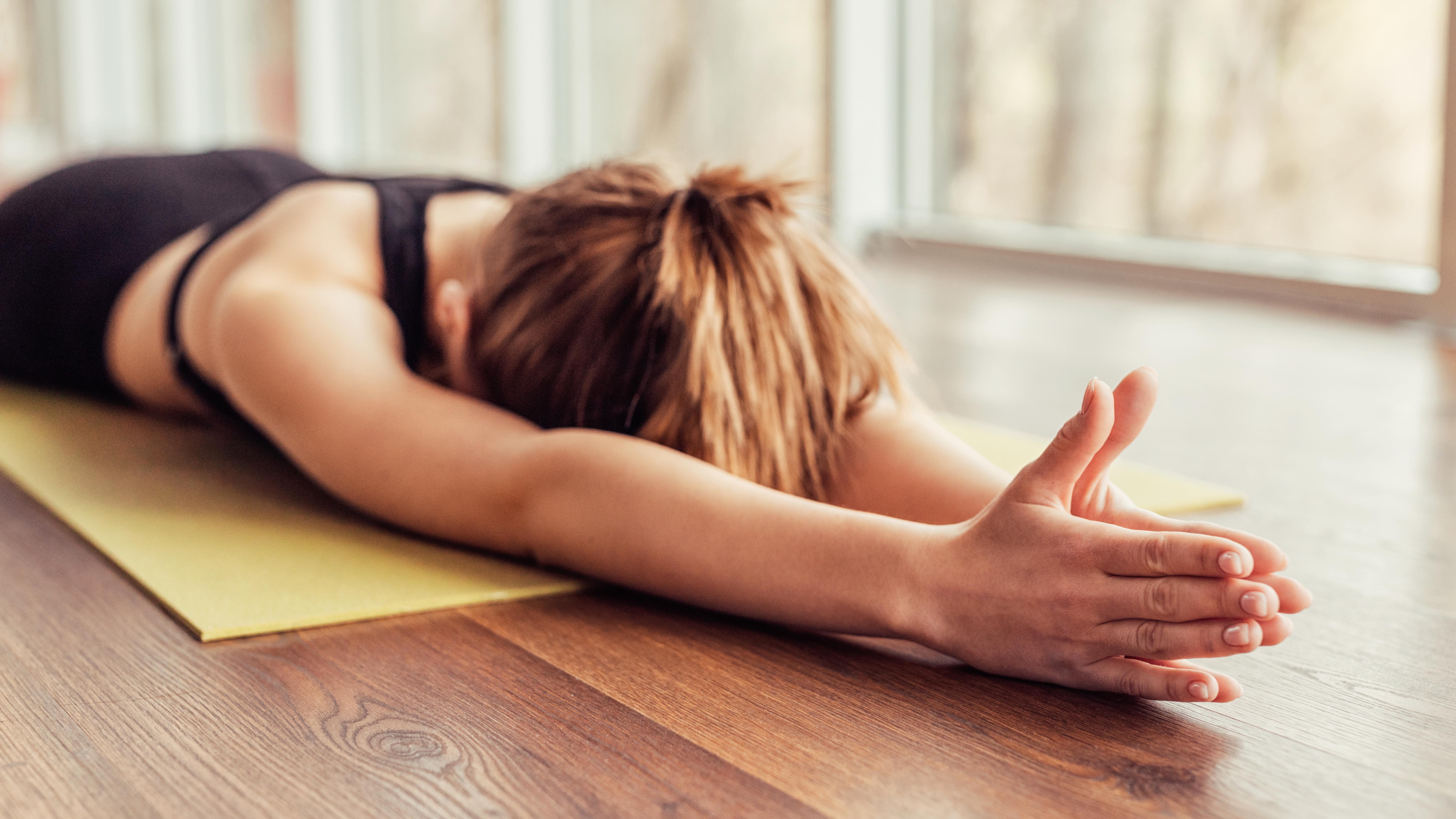 a woman doing yoga on a yoga mat