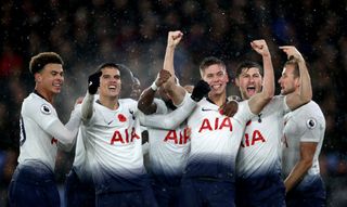Tottenham defender Juan Foyth (third right) celebrates scoring in the rain against Crystal Palace