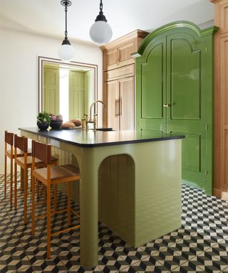 retro green kitchen with arched island and black and white patterned floor
