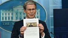 TOPSHOT - US Secretary of Treasury Scott Bessent shows a proposed $250 bill featuring President Donald Trump during a press briefing in the Brady Briefing Room of the White House in Washington, DC, on May 28, 2026. President Donald Trump could soon appear on a new $250 bill, in the Republican's latest move to shatter US traditions by putting his personal stamp on national institutions. A proposal for the new bill, featuring a glaring Trump, was first reported Thursday by the Washington Post. (Photo by Kent NISHIMURA / AFP via Getty Images)