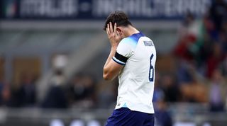 Harry Maguire holds his head during England's 1-0 defeat to Italy at the San Siro in the UEFA Nations League.