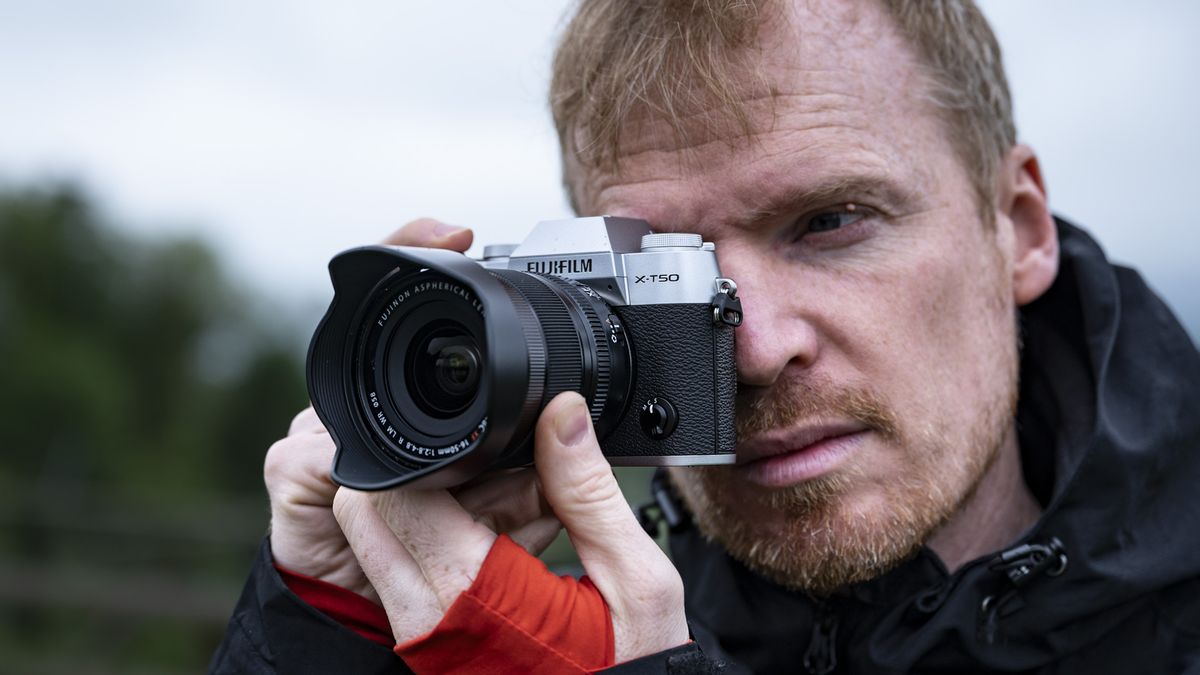 Photographer holding the Fujifilm X-T50 camera up to their eye