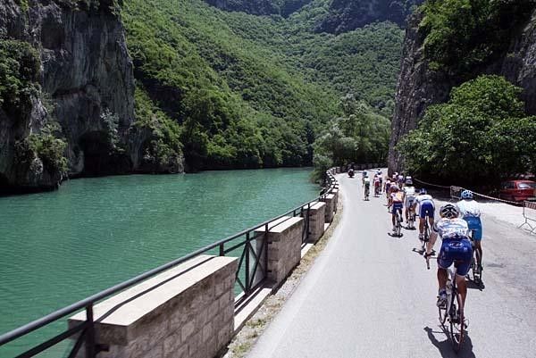 The peloton raced along a river.