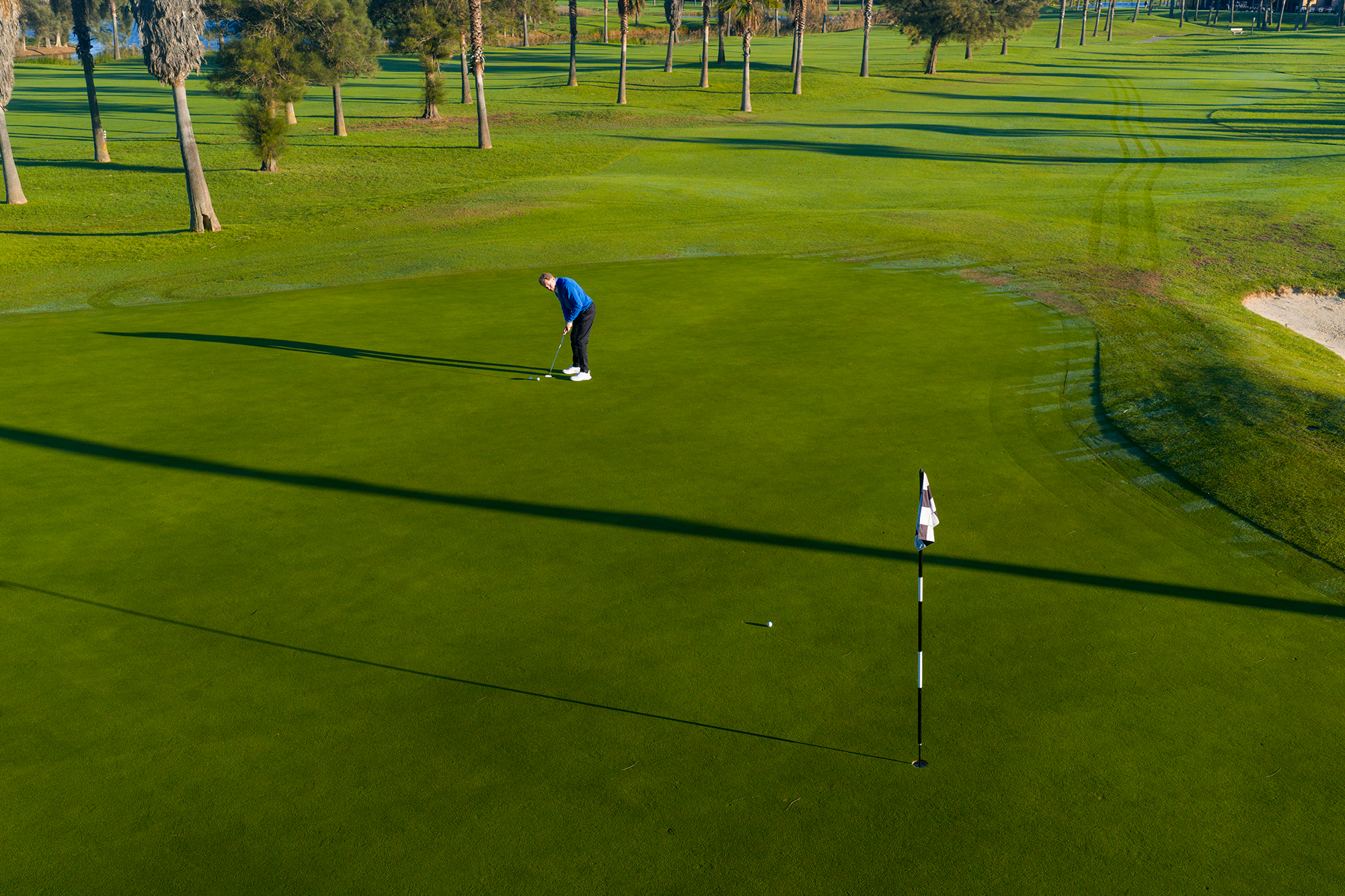 Keith Wood hitting two long putts towards the pin with one ball travelling at half way along its journey