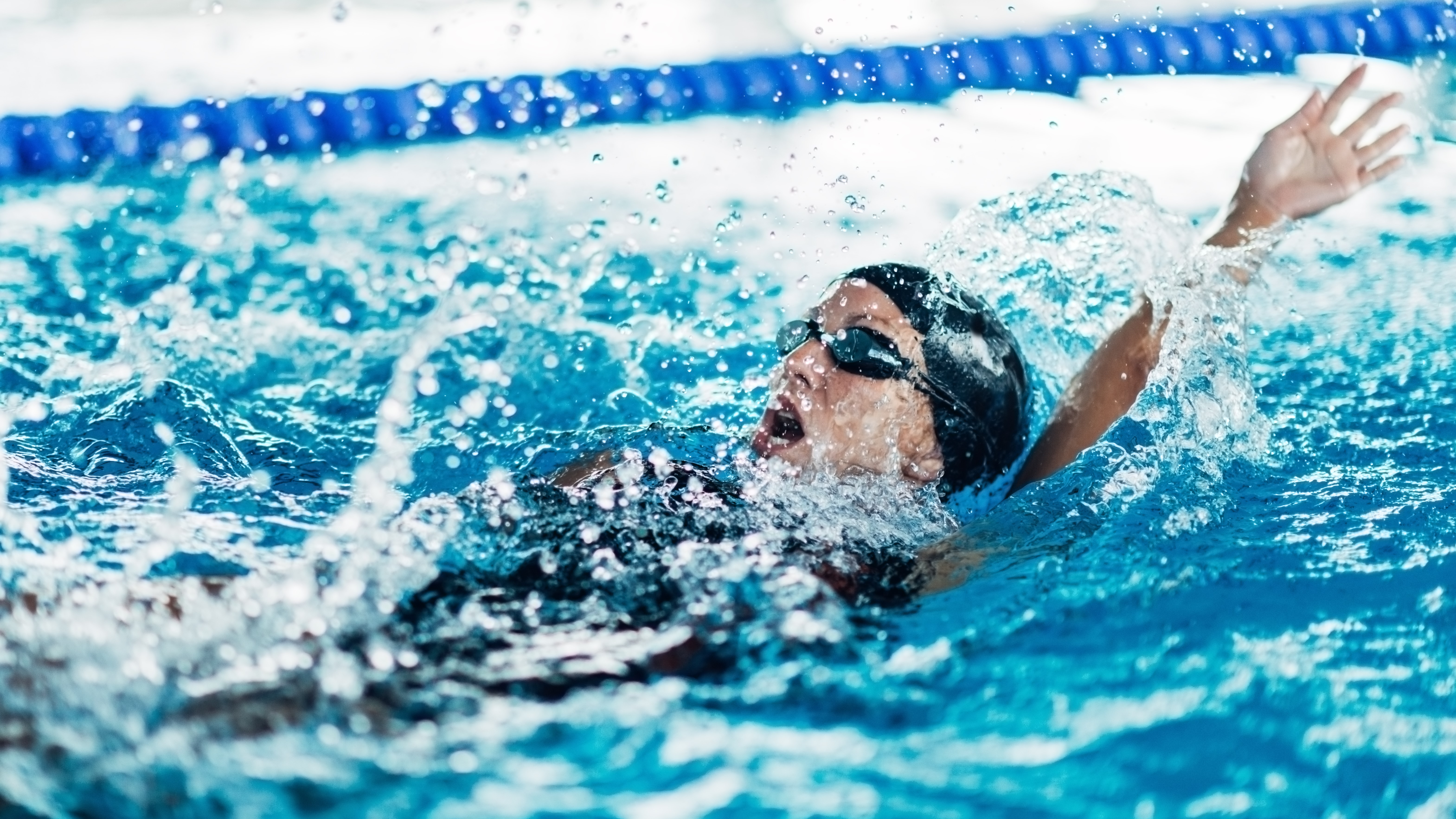 a photo of a woman swimming backstroke